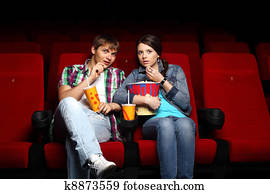 http://cdn-grid.fotosearch.com/CSP/CSP887/young-couple-in-cinema-watching-movie-stock-photograph__k8873559.jpg