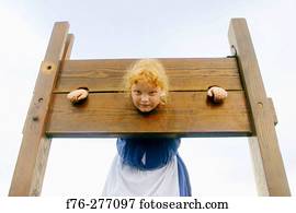 Child locked in 1700?s pillory at the annual Pequawket Alliance re-enactment of 1790?s life. Jefferson, New Hampshire. USA