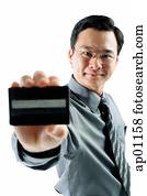 Businessman holding credit card, looking at camera