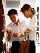 Couple in antique shop, looking at bottle