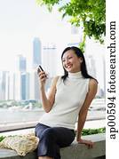 Young woman, looking at mobile phone, smiling Young woman, looking at mobile phone, smiling