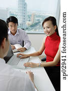 Executives having a discussion, woman using laptop   