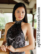 Woman in halter dress, looking at camera Woman in halter dress, looking at camera