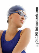 Young woman in swimming cap and goggles, head shot Young woman in swimming cap and goggles, head shot
