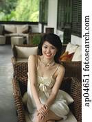 Young woman in sleeveless dress smiling at camera Young woman in sleeveless dress smiling at camera