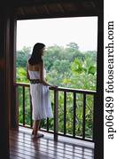 Young woman standing on balcony