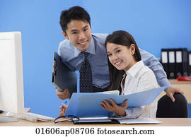 Businessman and woman smiling at camera