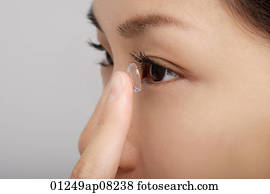 un, mujer joven, pone, un, lente de contacto, en