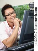 Man using computer and webcam