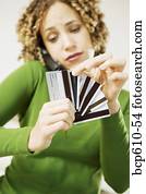 Woman on phone choosing credit card