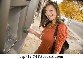 Woman smiling and using ATM