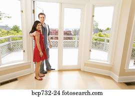Couple standing in doorway of new house