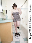 Woman standing on scale