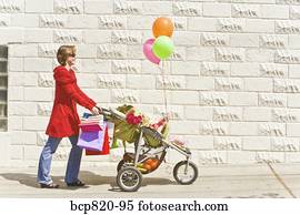 Woman pushing baby girl in stroller