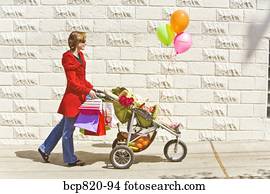 Woman pushing baby girl in stroller