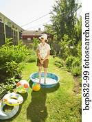 Woman standing in a wading pool