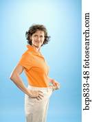 Woman wearing loose pants to show weight loss