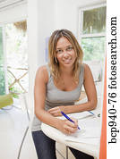 woman paying bills in home office