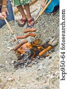 hot dogs roasting over beach fire