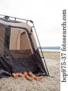 Children playing in tent on beach