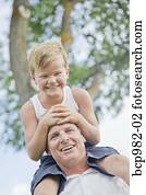 Father with his young son on his shoulders