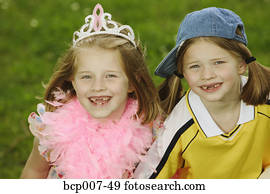 Twin girls dressed in contrasting styles.