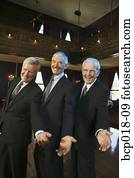 Three senior men holding out their hands on the dance floor.