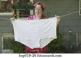 Woman behind a huge pair of underwear on a clothesline.