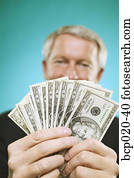 Man holding a fan of money.