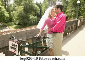 Newlyweds with a tandem bike Newlyweds with a tandem bike