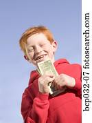 Happy boy holding American currency