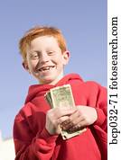 Happy boy holding American currency