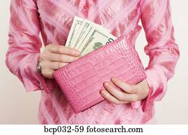 Woman removing American currency from purse