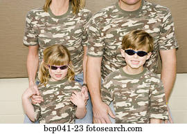 Young children with parents in camouflage