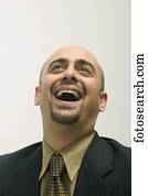 Mid adult man laughing