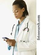 Female doctor operating a hand held device