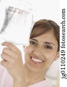 Female nurse holding up an iv bag