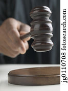 Human hand holding a gavel