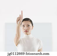 Mid adult woman touching a screen