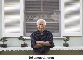 Portrait of a senior man standing with his arms crossed Portrait of a senior man standing with his arms crossed