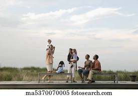 Families playing on wooden benches