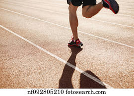 Male athlete running on a track