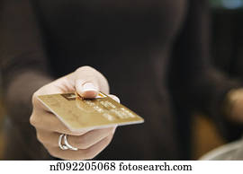 Young woman paying with a credit card