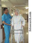 African female doctor helping patient with walker, Bethesda, Maryland, United States