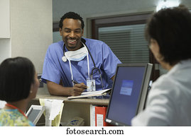 African male surgeon talking to co-workers, Bethesda, Maryland, United States