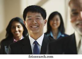 Asian businessman with co-workers in the background