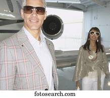 Couple standing in front of airplane in a hanger, Nobato, California, United States
