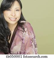 Studio shot close up of Asian woman smiling