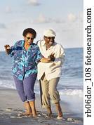 Senior African American couple dancing on beach