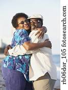 Senior African American couple hugging outdoors Senior African American couple hugging outdoors